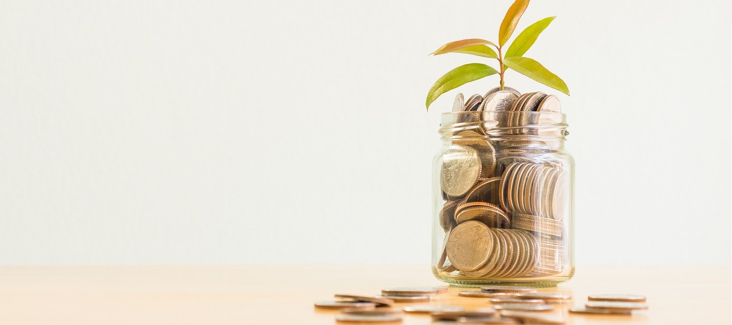 jar of coins with plant growing