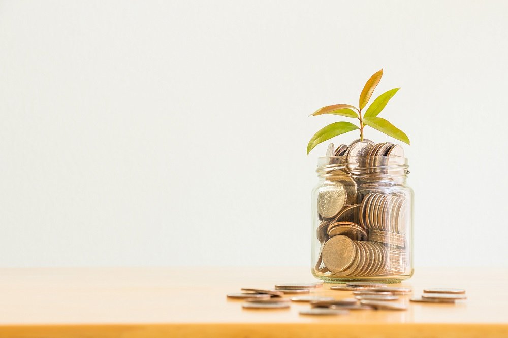 jar of money with plant growing out of it