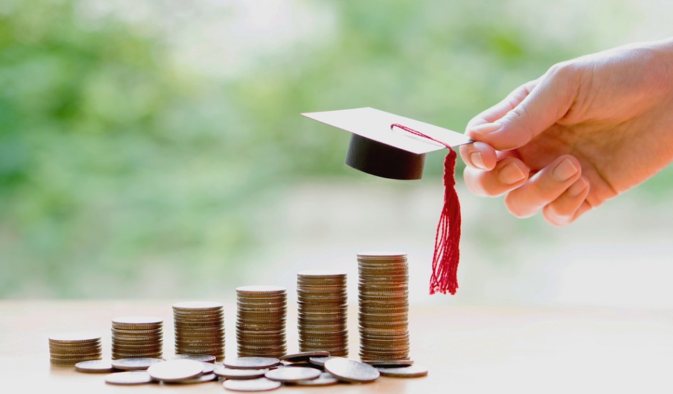 coins stacked with graduation cap