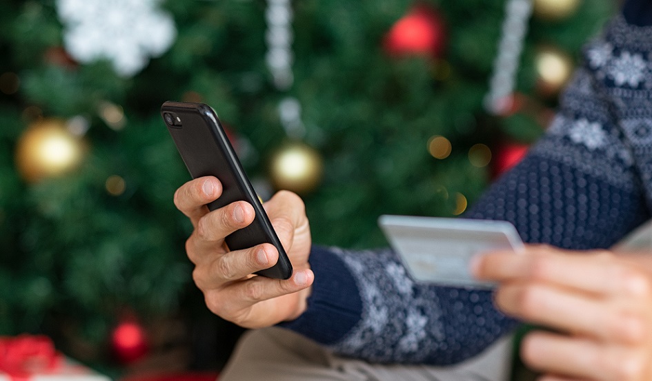 hand holding phone and credit card