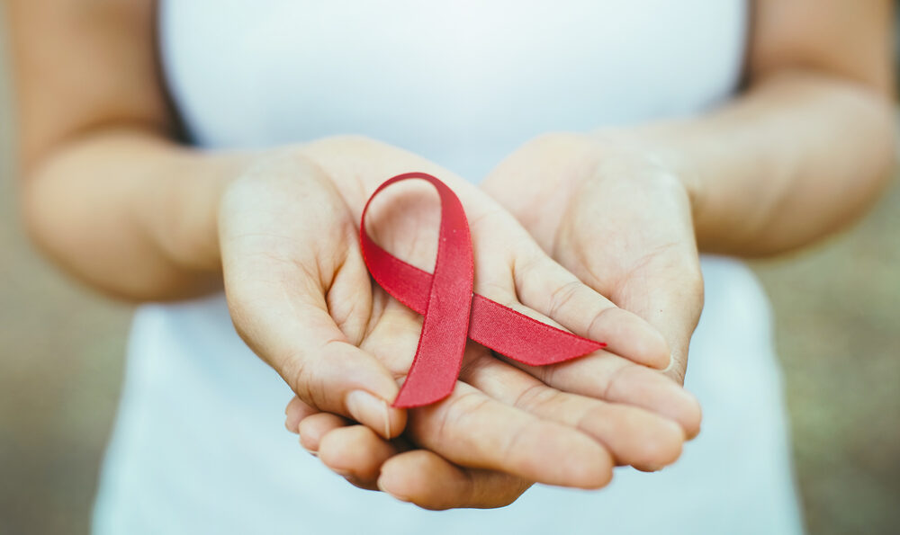 hands holding a red ribbon