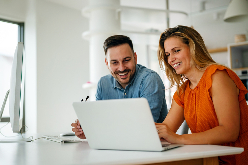 Portrait of success business people working together in home office. Couple teamwork startup concept