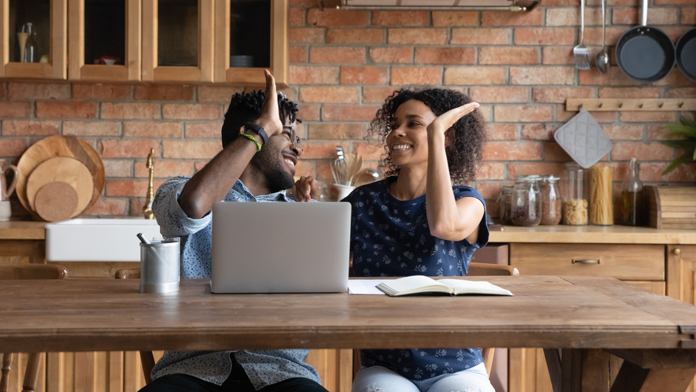 Happy Successful Afro Couple Celebrating At Laptop