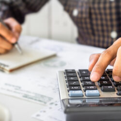 Businessman,Hand,Using,Calculator,Calculating,Bonus(or,Other,Compensation),To,Employees